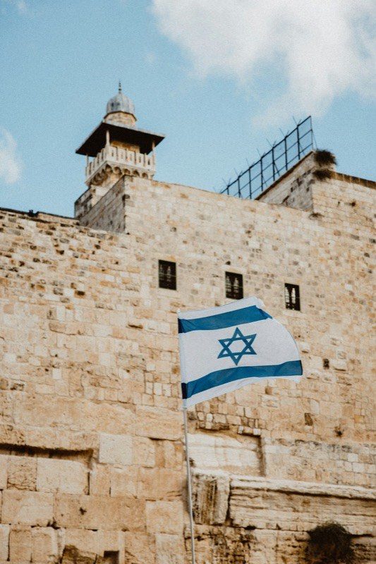 An Israeli flag before the ancient walls of Jerusalem