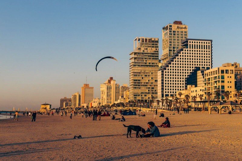 A golden-hour view of the Tel Aviv beachfront and skyline